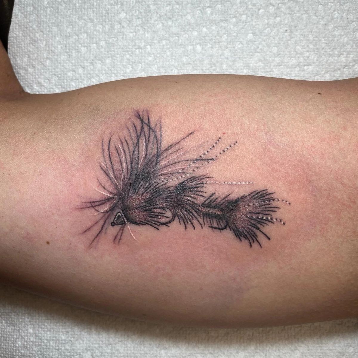 tackle tattoo in black ink